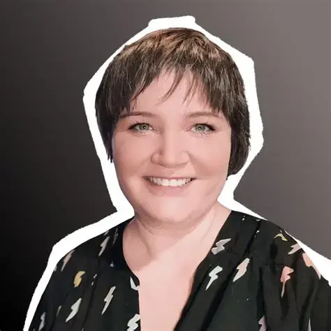 Nichalia “Nikki” Schwartz, smiling, in a black shirt with lightning bolts